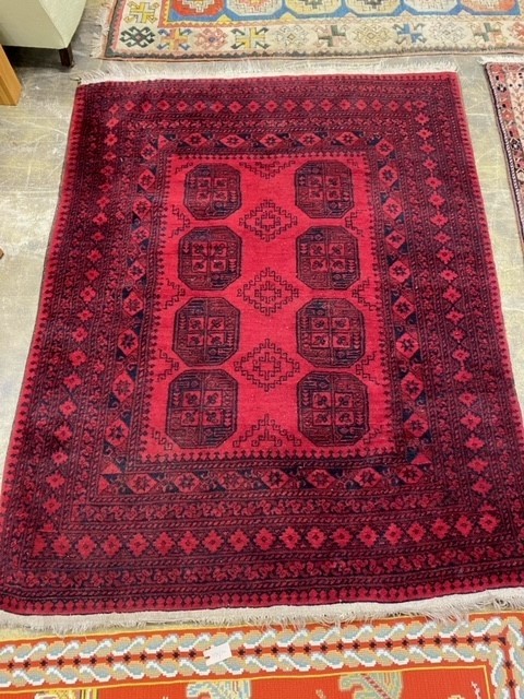 An Afghan red ground rug. 200x158cm.